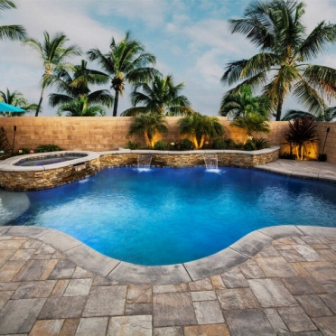 Freeform Traditional Pool with Stone Wall and Spa
