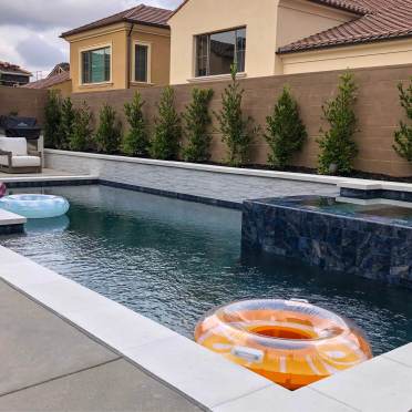Modern Swimming Pool with White Stone and Coping with Tile Spa