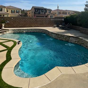Freeform Swimming Pool with Stone Back Wall