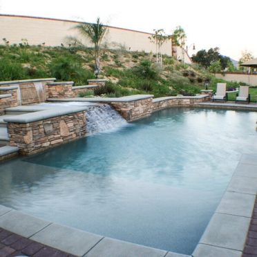 Traditional Swimming Pool with Spillways and Raised Spa