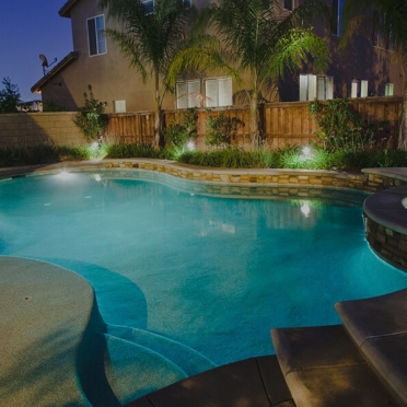 Traditional Swimming Pool with Stone Accents and Baja Step